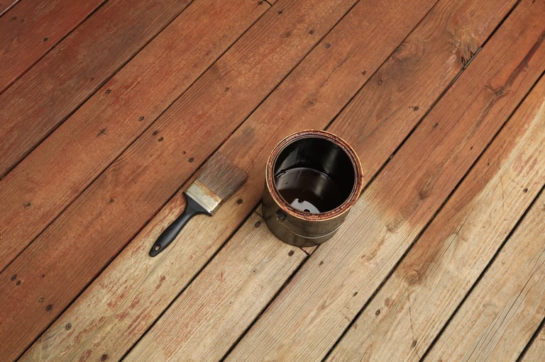 Wood deck being stained with brush